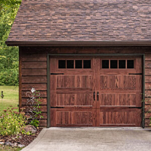 A wood garage door on a rustic home.
